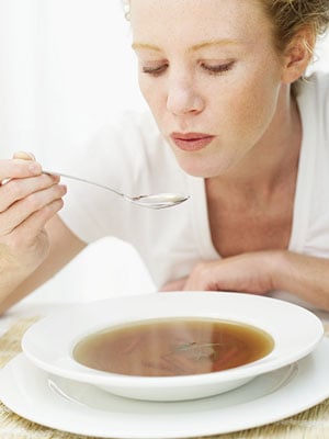 woman eating hot soup